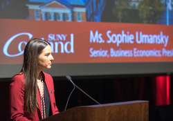 Umansky speaking at a podium in Corey Union